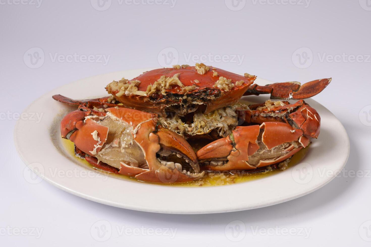 BUTTER GINGER CRAB WOKKIN in a dish top view on grey background singapore food photo