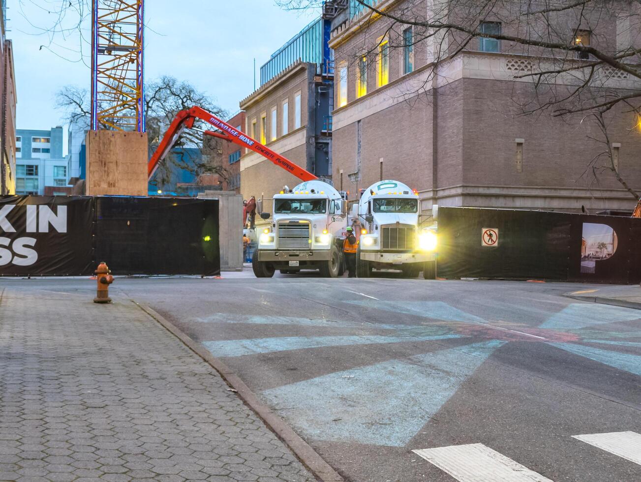 Portland, Oregon, USA -03.07.2024 Work at a construction site in the city center. Construction of a multi-apartment building. Unloading concrete.. photo