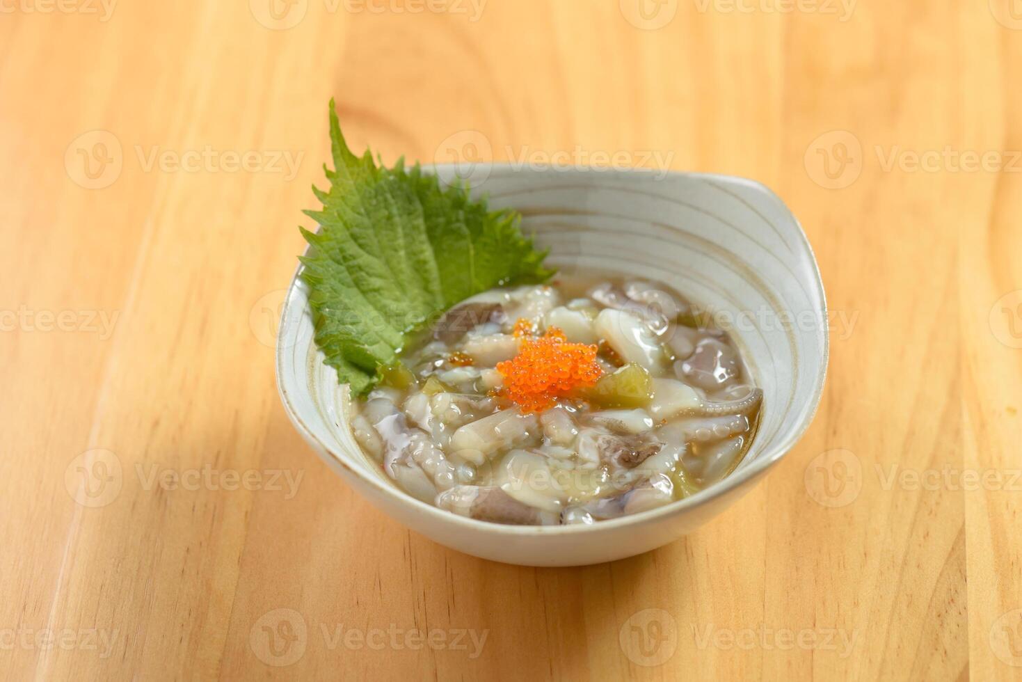 japanese food Octopus Tako Wasabi served in a bowl isolated on wooden table top view photo