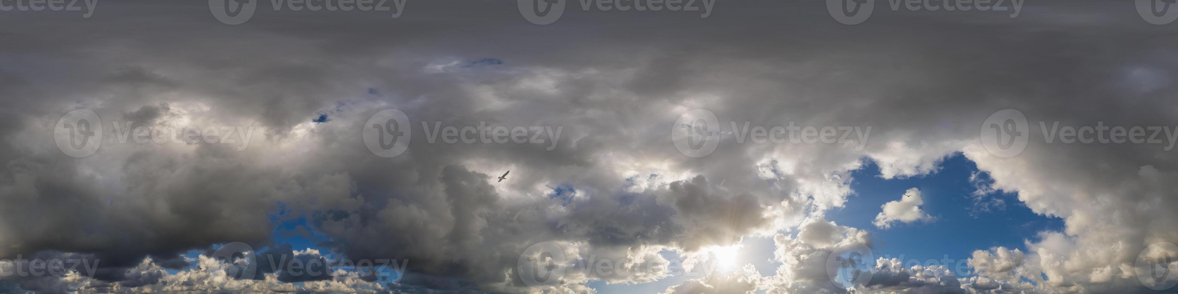 Dark blue sunset sky panorama with Cumulus clouds. Seamless hdr pano in spherical equirectangular format. Complete zenith for 3D visualization, game and sky replacement for aerial drone 360 panoramas. photo