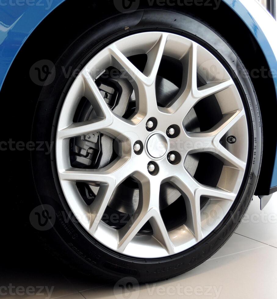 Low profile tire on multi-spoke sports vehicle rim angle view photo