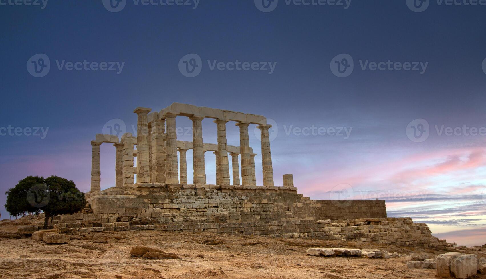 The famous temple of Poseidon in Greece with cloudy sky. In Greek mythology, the god of the sea. Cape Sounion, Ruins of the ancient temple during cloudy weather. photo
