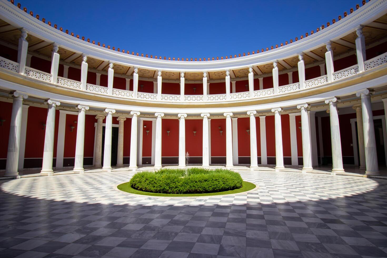 1 September 2023, Athens, Greece. The beautiful view of the Zappeion mansion inner yard. The harmony of red, green, and white. Famous place for official and private meetings and ceremonies. photo