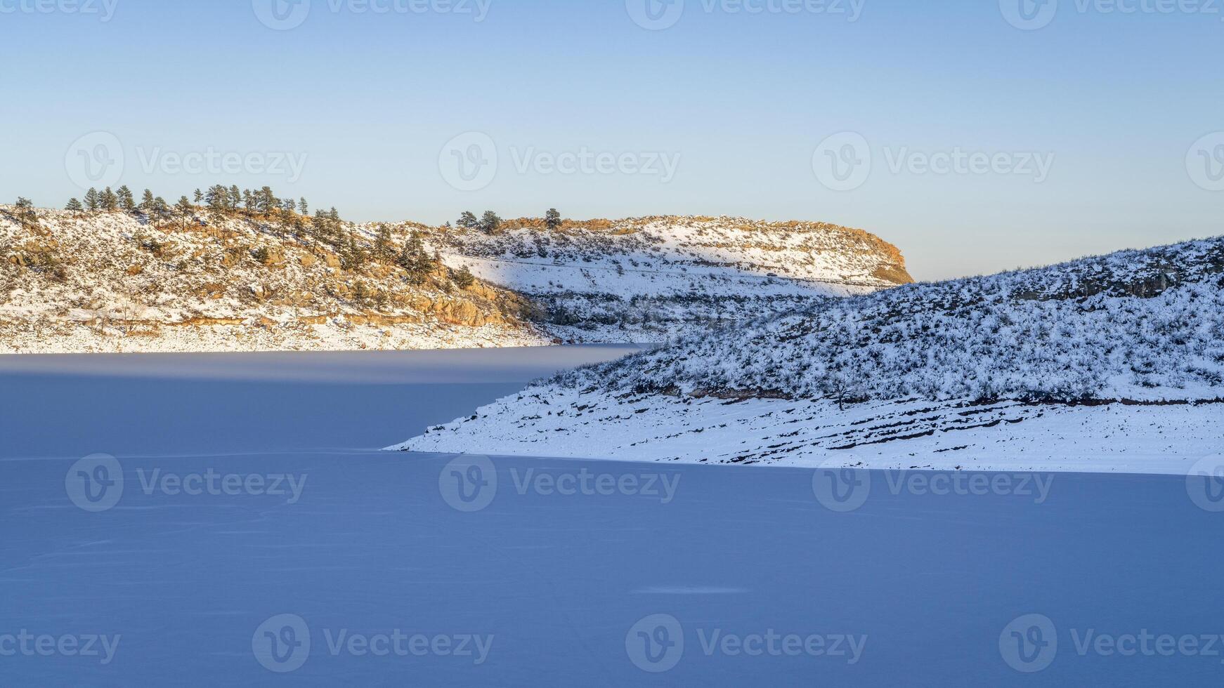 winter sunset over frozen Horsetooth Reservoir and Satanka Cove at foothills of northern Colorado photo