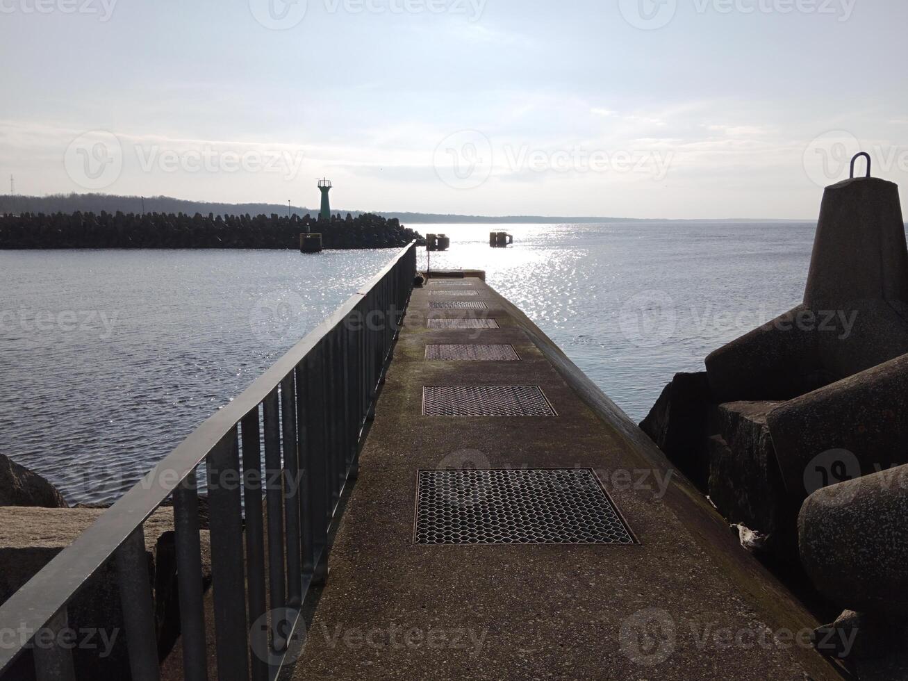 Taking a stroll along the port and pier in Kolobrzeg, Poland, offers a delightful experience with picturesque views of the Baltic Sea and the bustling maritime activity. photo