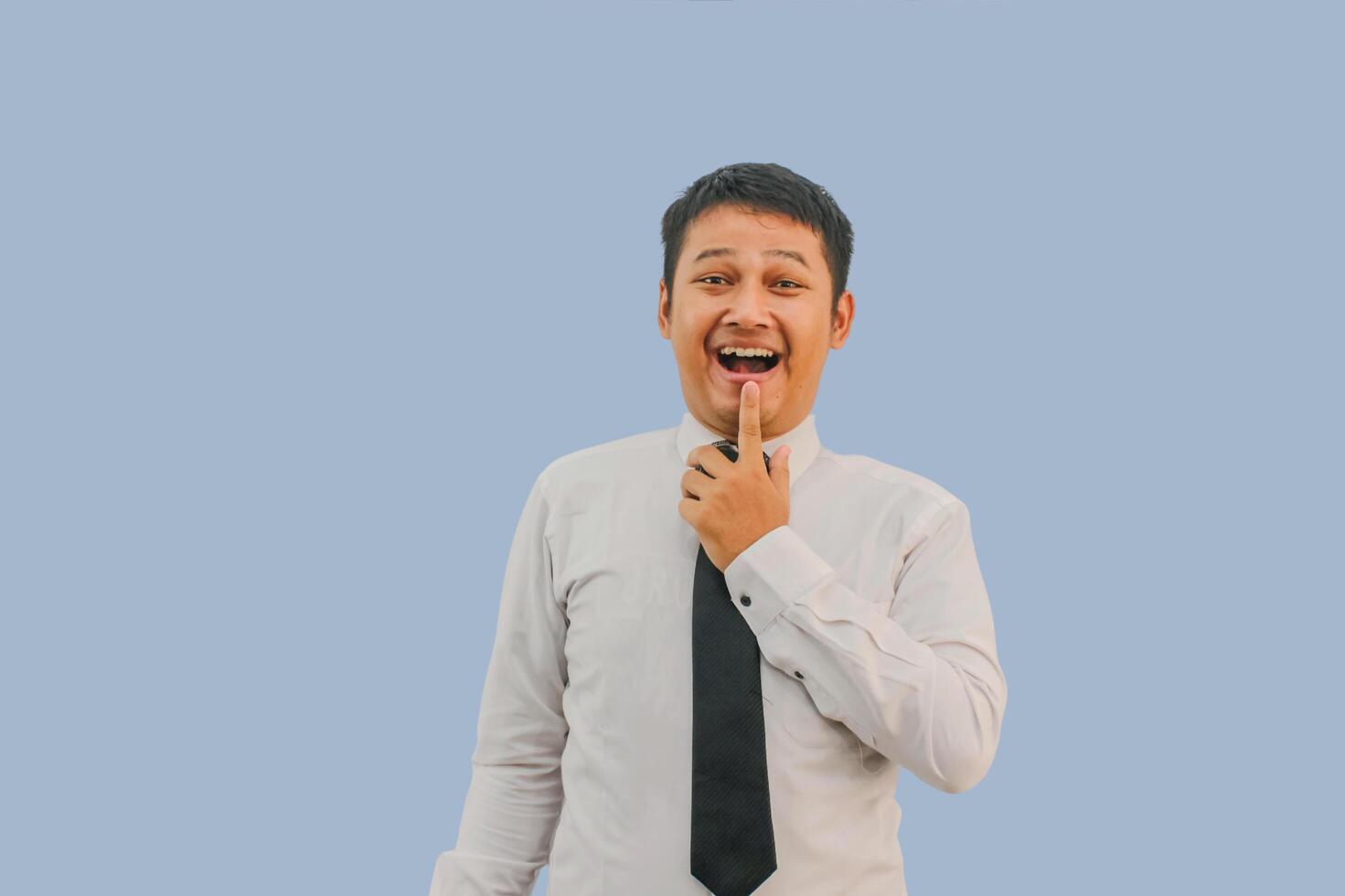 Adult Asian man showing excited face expression while pointing finger up photo
