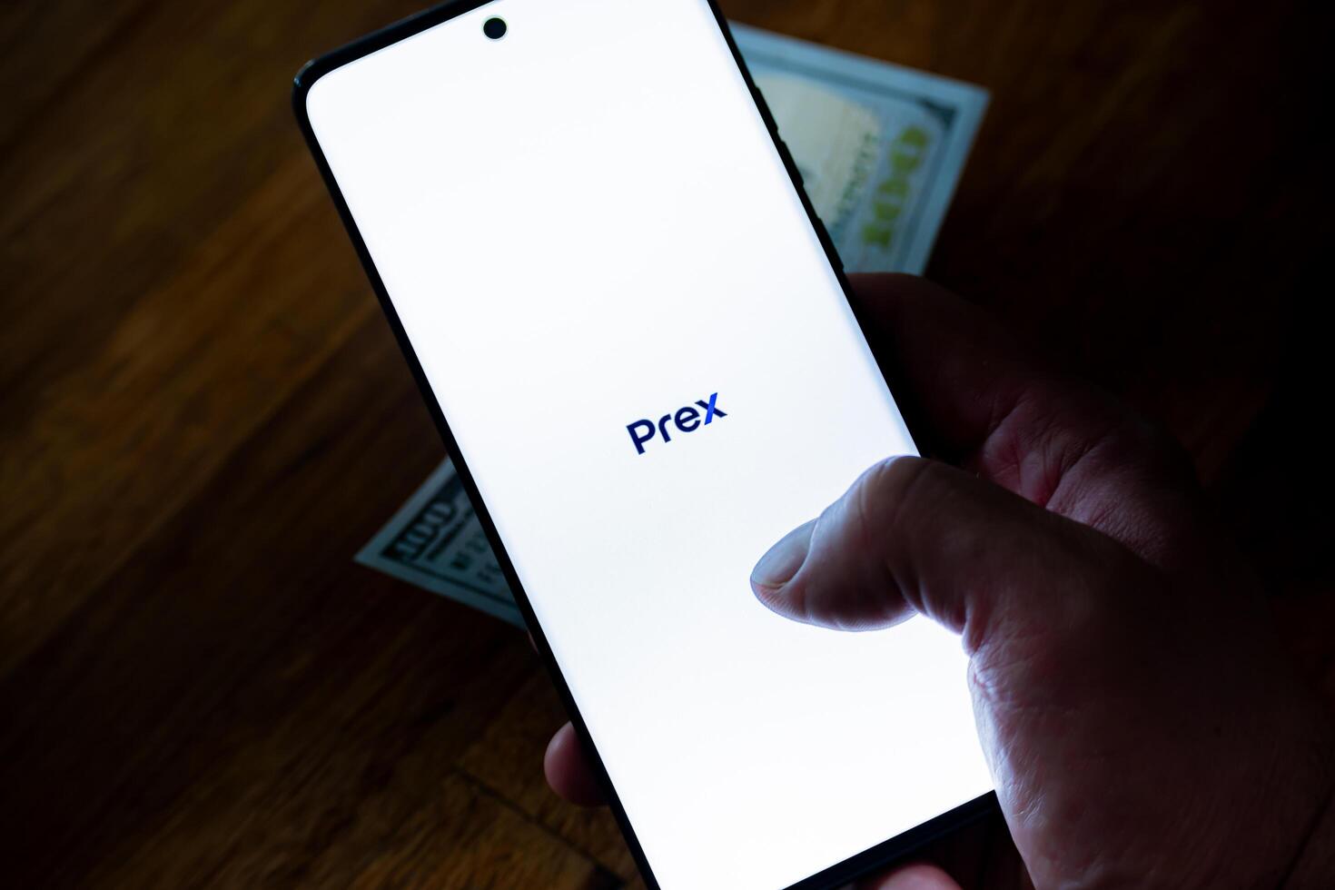 Cordoba Province, Argentina, March 11, 2024, Hand of a person holding a cell phone that is running the Prex mobile application. Prex is a virtual wallet used in Argentina and Uruguay. photo