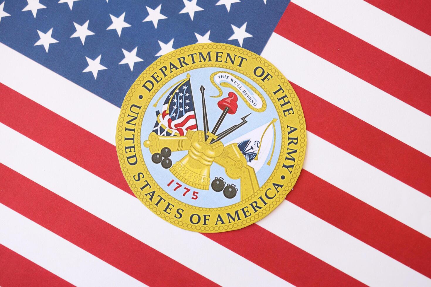 KYIV, UKRAINE - MARCH 9, 2024 US Department of Army seal on United States of America flag photo