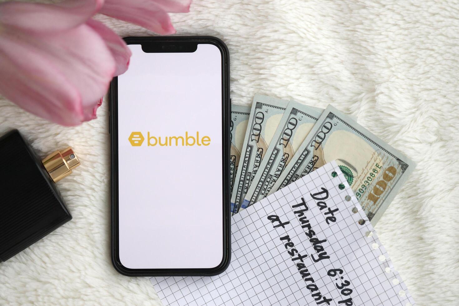 KYIV, UKRAINE - FEBRUARY 23, 2024 Bumble logo of famous dating website or app on iPhone display photo