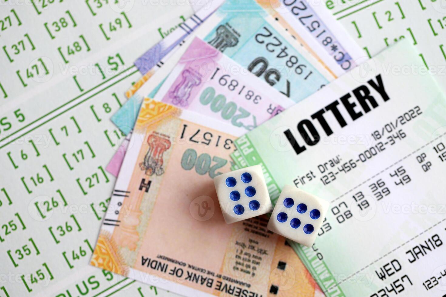 Green lottery tickets and indian rupees money bills on blank with numbers for playing lottery photo