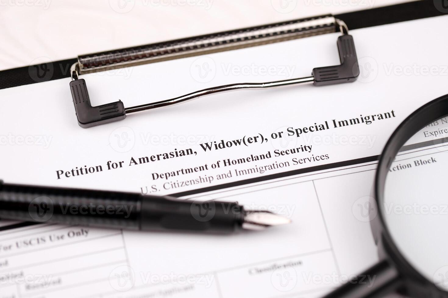 I-360 Petition for Amerasian, Widower or special immigrant blank form on A4 tablet lies on office table with pen and magnifying glass photo