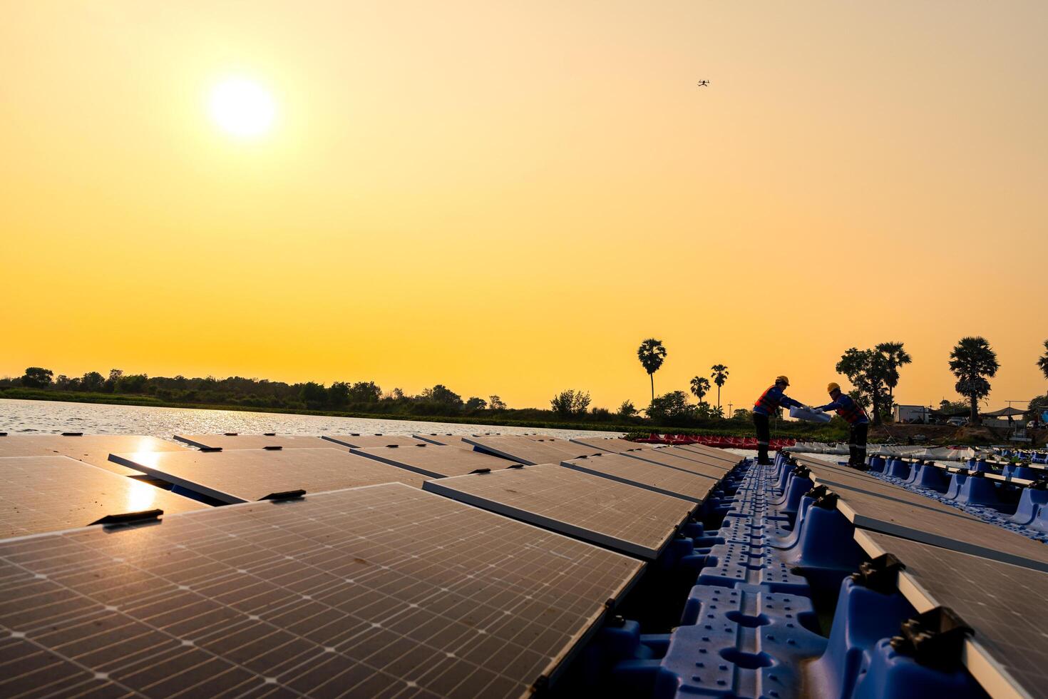 Photovoltaic engineers work on floating photovoltaics. workers Inspect and repair the solar panel equipment floating on water. Engineer working setup Floating solar panels Platform system on the lake. photo