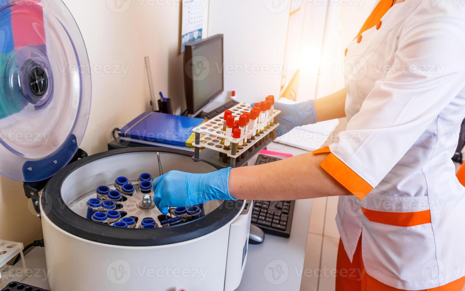 Blood samples for research in microtubes. Testing in laboratory. Centrifuge for blood analyzing. Chemical research. Prevention. Pneumonia diagnosing. COVID-19 and coronavirus identification. Pandemic. photo