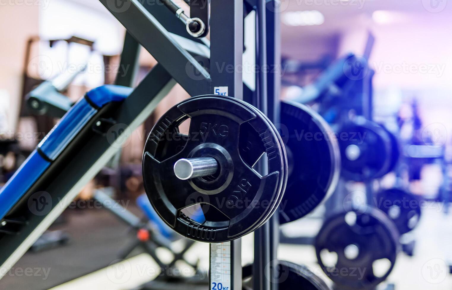 Fitness exercise equipment barbells in the sports gym. Black barbell plates in sport fittness center. Close-up photo