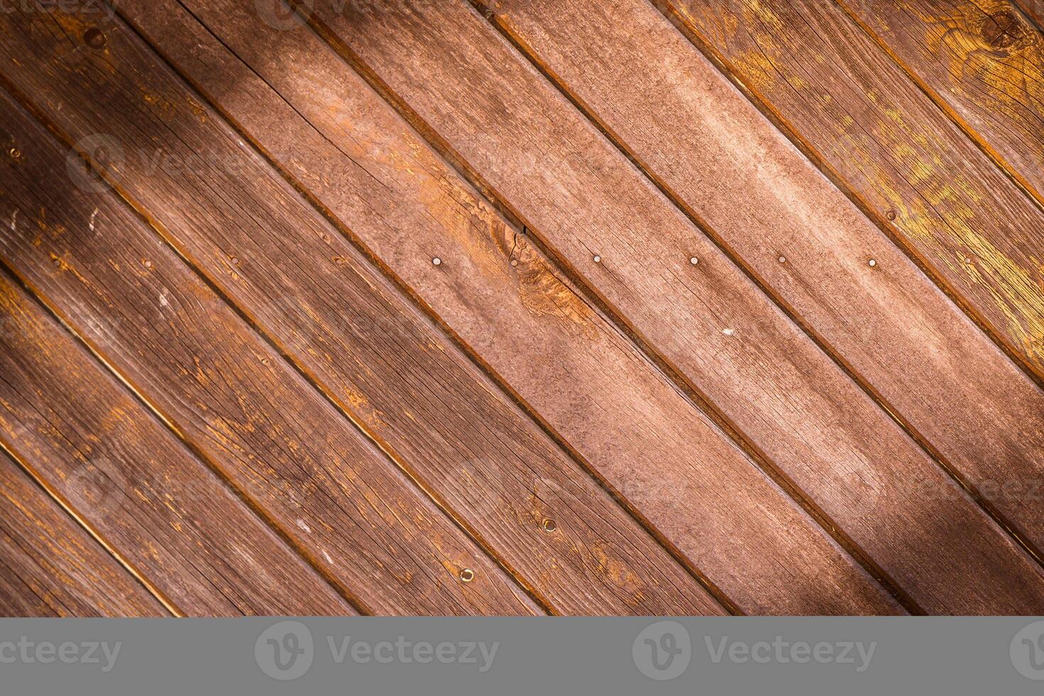 Wooden wall made of diagonal boards with light brown stripes. Background.1 photo