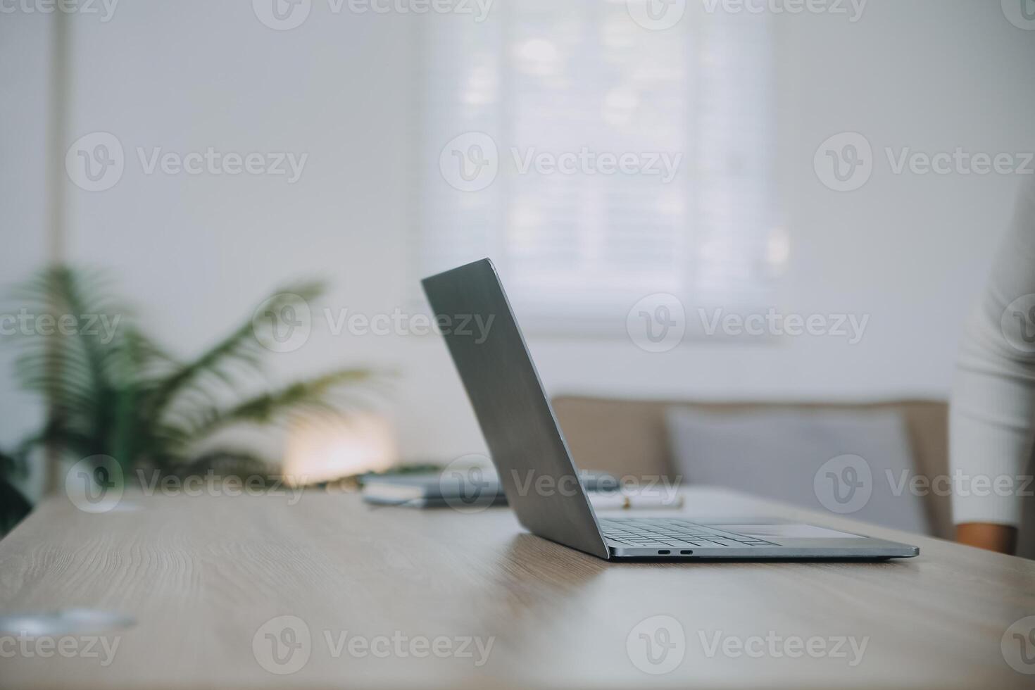 Successful female grapic designer watching tutorial about creative ideas at laptop computer during working process in office.Positive student with blonde hair reading business news on netbook photo