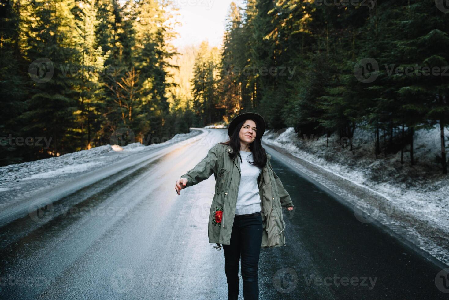 Happy girl with hat in forest at mountain road background, Relax time on holiday concept travel ,color of vintage tone and soft focus photo