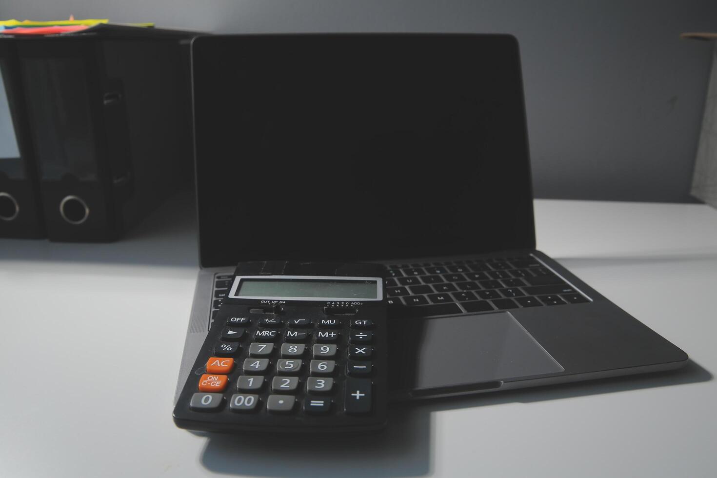 Flat lay, top view office table desk. Workspace with calculator,pen,laptop on white background.Copy Space for text,Empty Blank to word.Business Finance,Education Technology.Work from home. photo