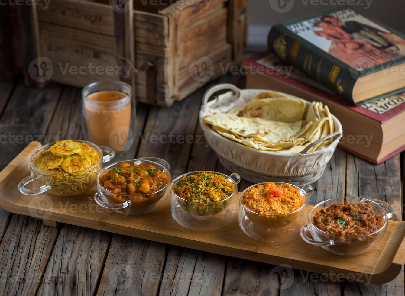 Assorted break fast set balalet or balaleet, aloo nakhi,aloo karahi, tomato egg, foul medames, Shakshuka or shaksoka with bread and coffee in dish isolated on board side view of breakfast photo