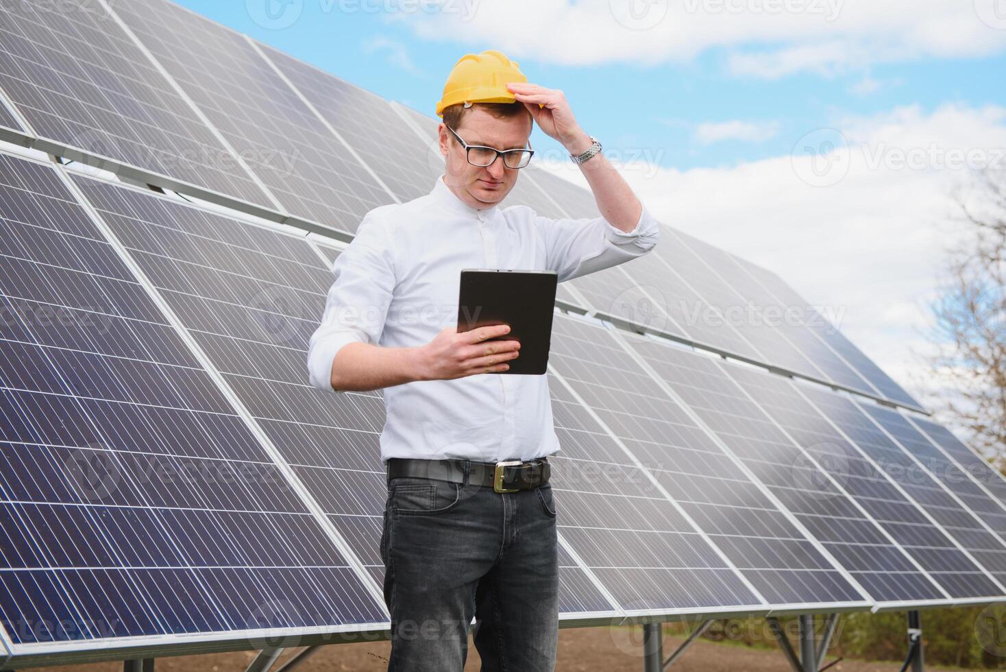 solar panels and blue sky.Man standing near solar panels. Solar panel produces green, environmentally friendly energy from the sun. photo