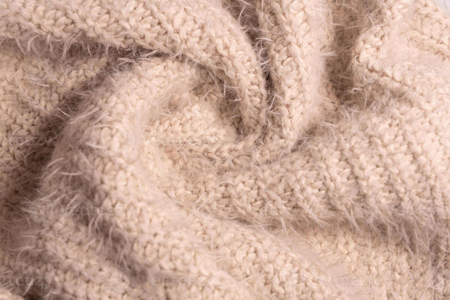 White knitwear texture. Soft texture of homemade cashmere wool sweater. photo