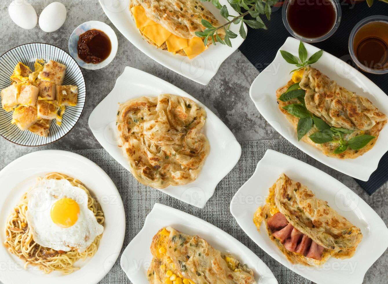 Assorted taiwan pancake food Corn and Egg Scallion pancake Grabs, Basil, cheese, onion, Bacon, black pepper Mushroom Sizzling Noodles, Carrot Cake with Eggs, winter melon tea, black tea served photo