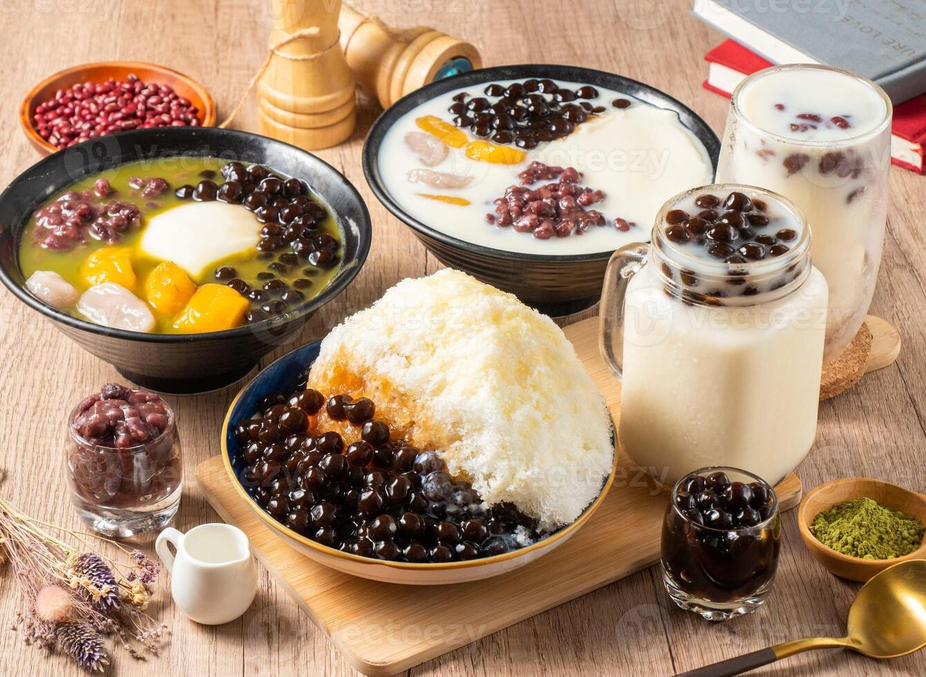 Assorted grass belly, mango, taro, soy milk, shaved ice, red beans, rice ball served in bowl isolated on table top view of asian food photo