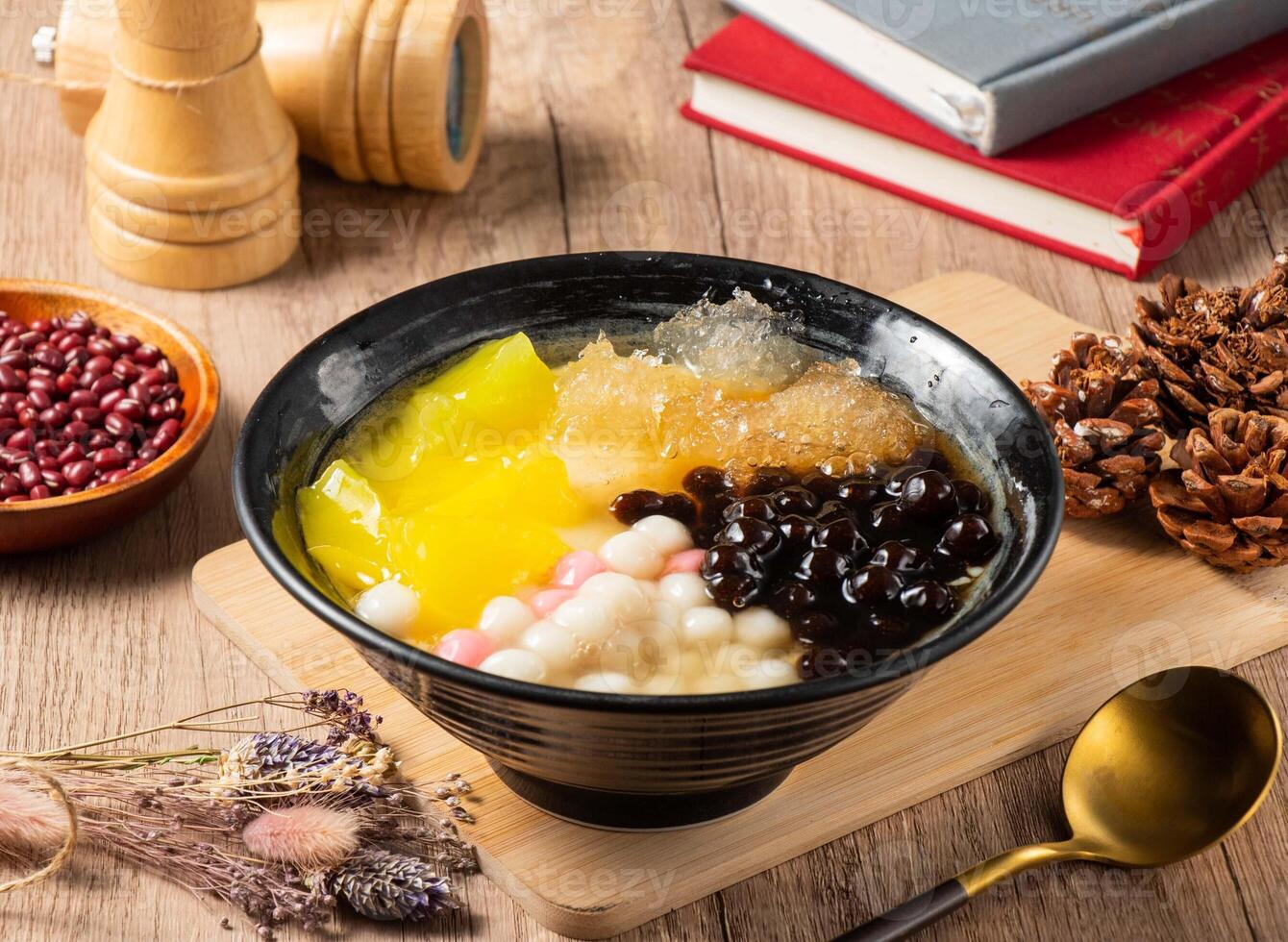 Tradition grass jelly, mango, beans and rice ball served in bowl isolated on table top view of asian food photo