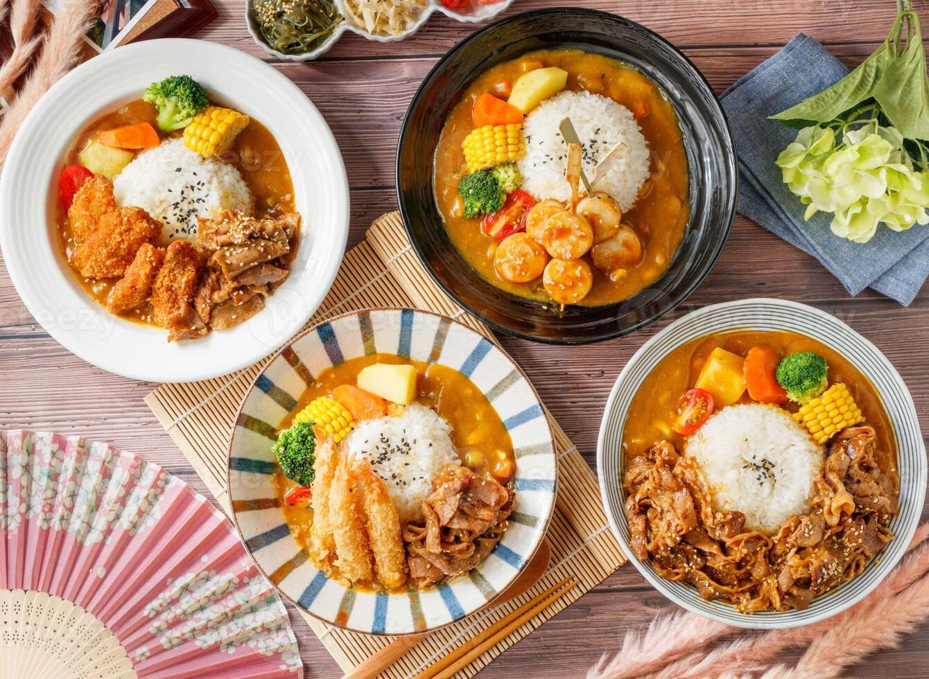 Assorted curry rice with chicken, beef, pork, shrimp, skewer, tender, served in dish isolated on table top view of taiwan food photo