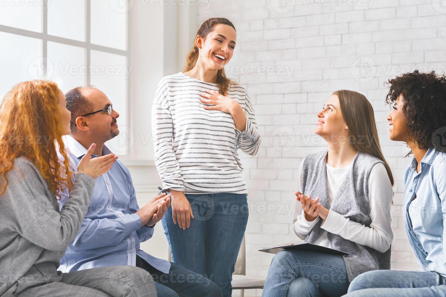 Happy welcoming woman at support group meeting, photo