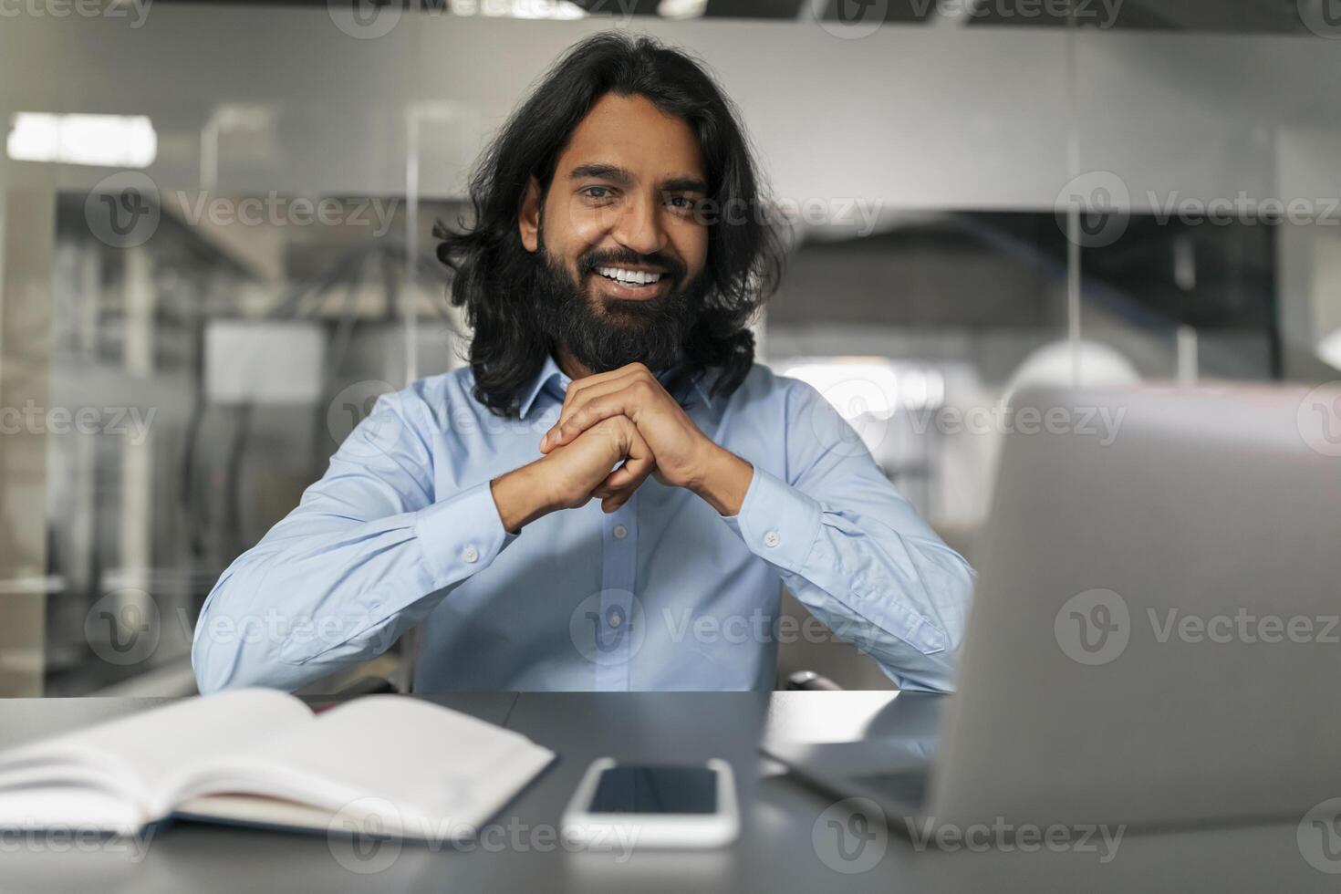 Happy man in office posing for photo