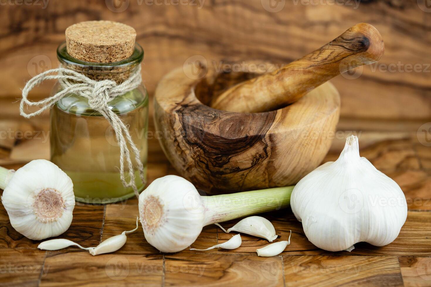 fresh Garlic for garlicoil on olive wood photo