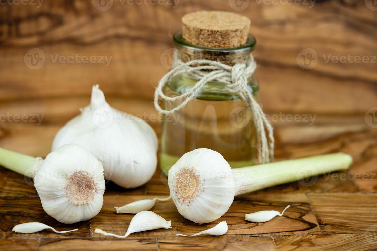 fresh Garlic for garlicoil on olive wood photo