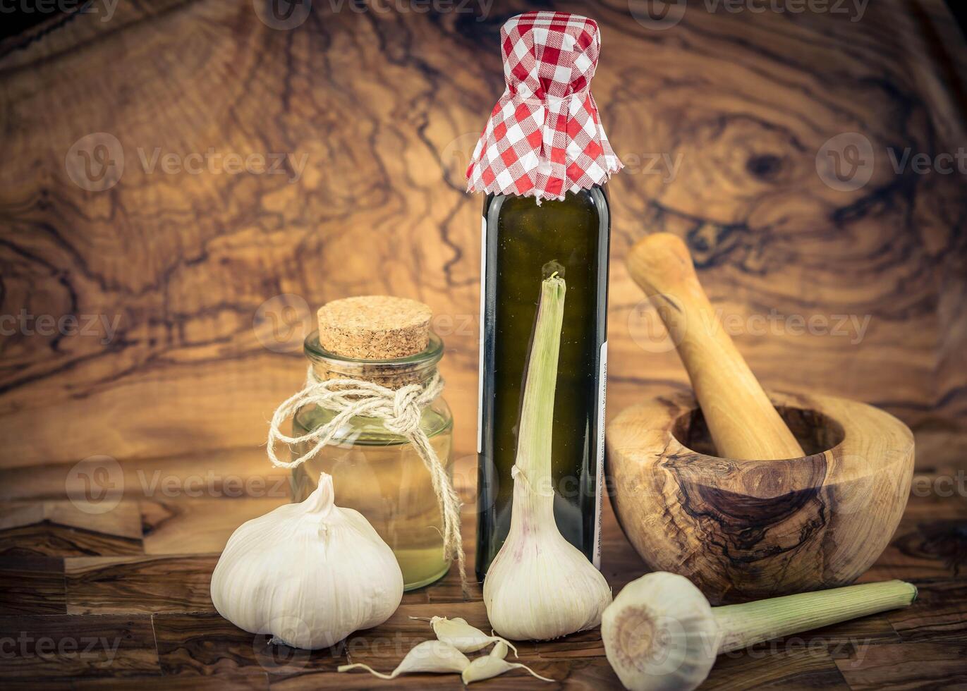 fresh Garlic for garlicoil on olive wood photo