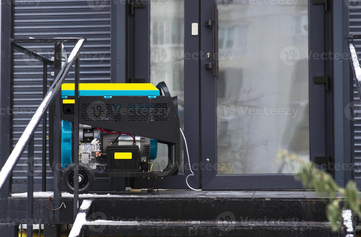 Portable electric generator running in the cold winter.Energy genocide. Power outage as a result of missile strikes by Russia on energy facilities of Ukraine. Small business use gasoline generators. photo
