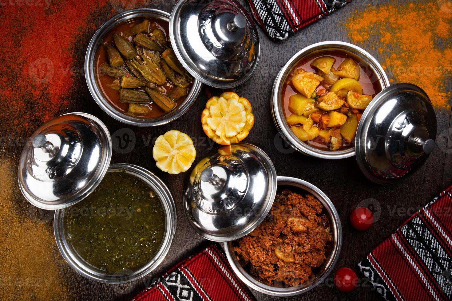 Assorted indian food with alu mutter, bhindi, keema, palak, saag and bhutta served in dish isolated on table top view of arabic food photo