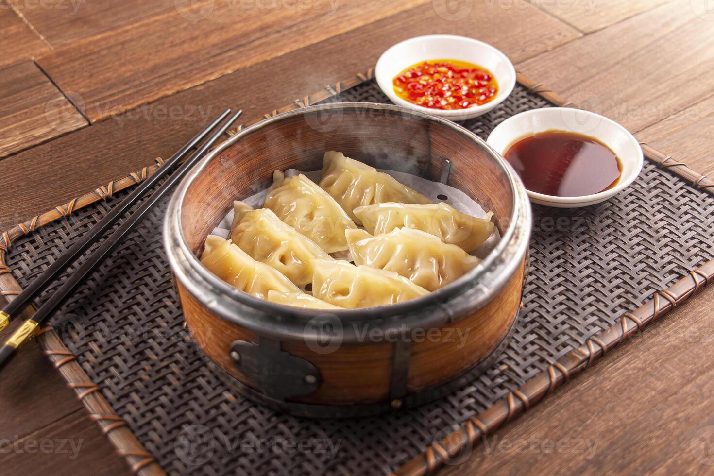 Bamboo Steamed Pork Dumplings with sauce served dish isolated on wooden table top view of Hong Kong food photo