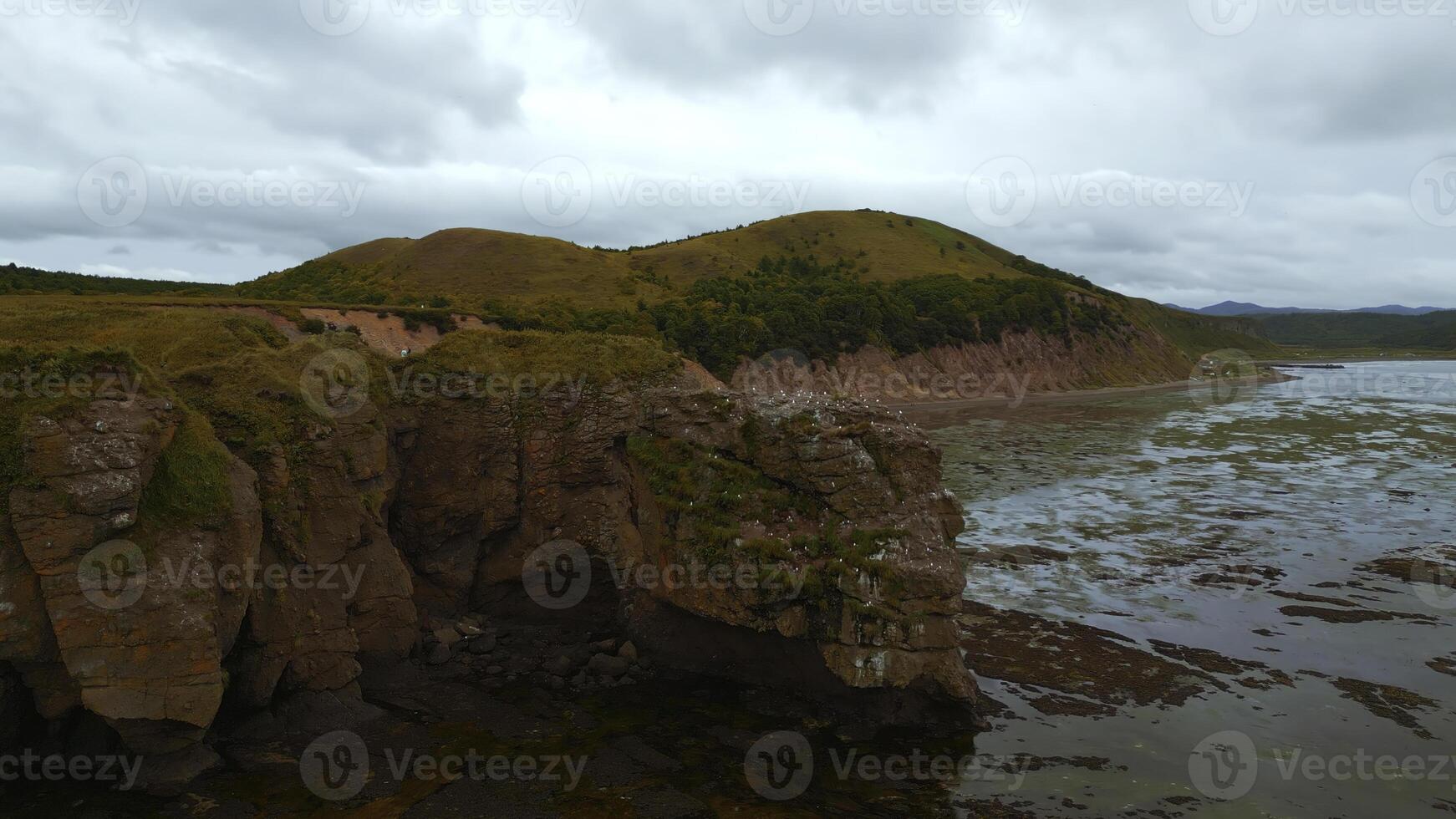 Rocky bay with swampy water. Clip. Amazing natural landscape with rocks in swampy sea bay. Rocky sea bay with algae photo