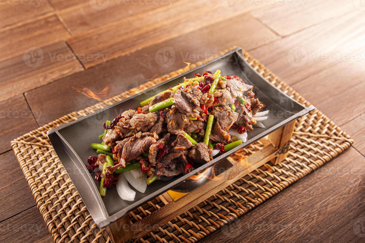 Spicy chilli Hunan Sizzling Beef served dish isolated on wooden table top view of Hong Kong food photo