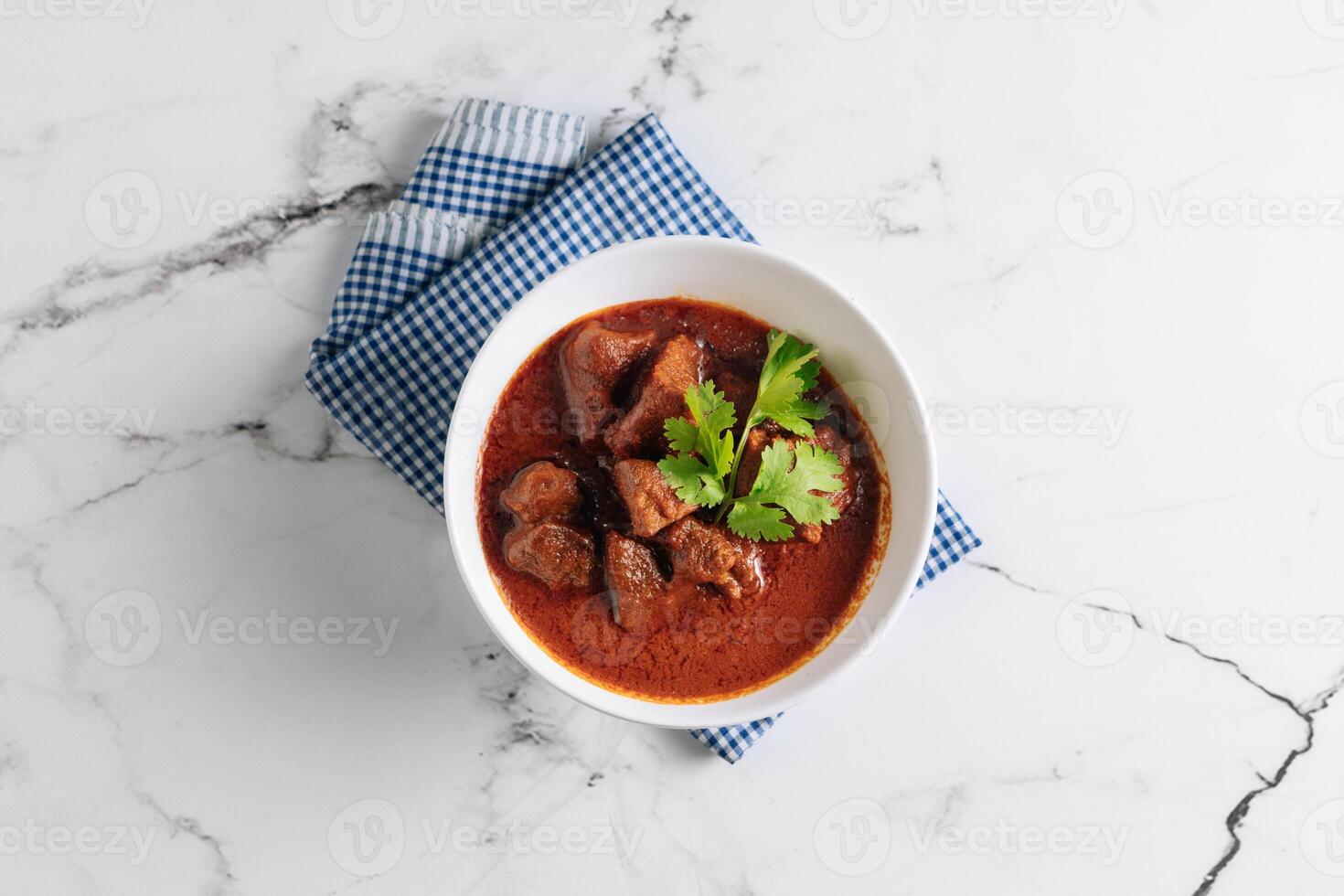 Mutton Rogan Josh, mutten qorma, mutten curry, mutton karahi in a dish isolated on napkin side view on grey background photo