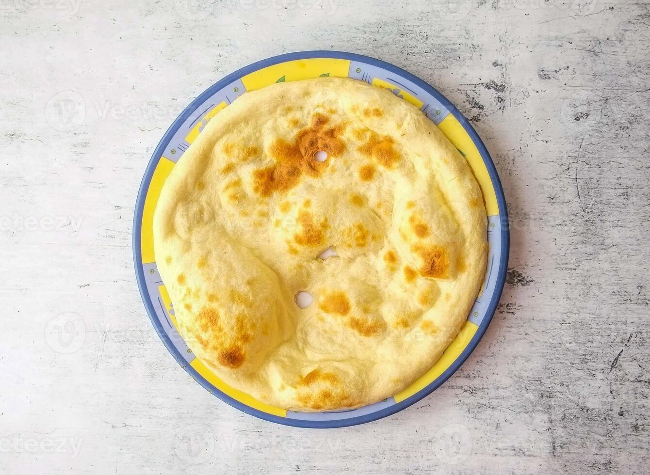 Tandoori naan or khamiri roti served in a plate isolated on background top view of indian and pakistani desi food photo
