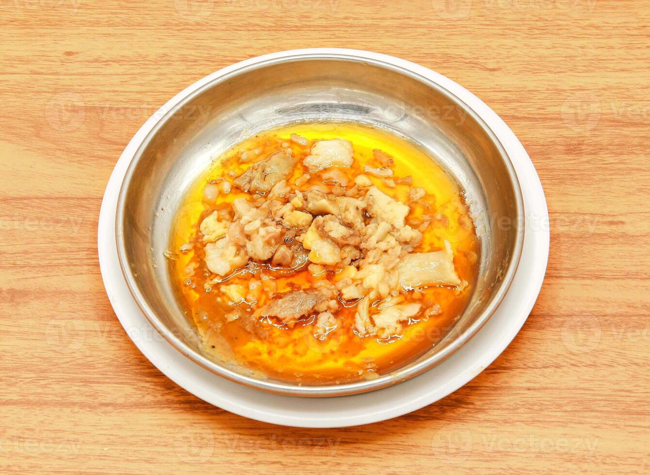 Nali nihari with lemon and ginger slice served in a dish isolated on wooden table side view of indian, pakistani food photo