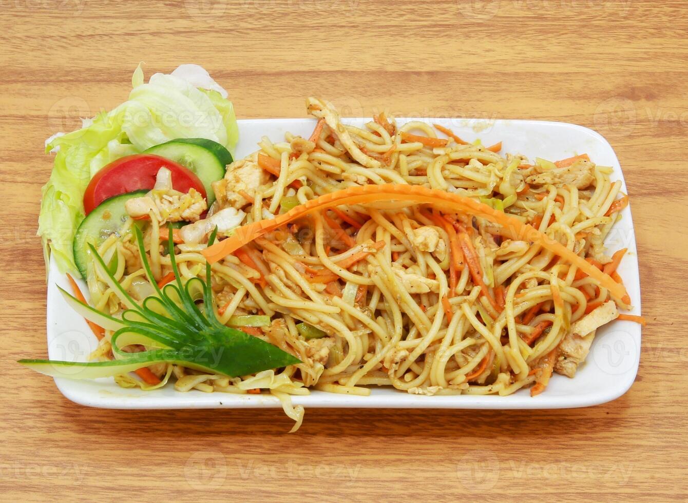 2376311 chicken chowmien with salad served in a dish isolated on grey background side view of indian, pakistani food photo