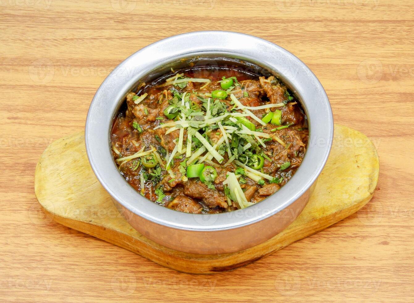Mutton boneless handi served in a dish isolated on grey background side view of indian, pakistani food photo