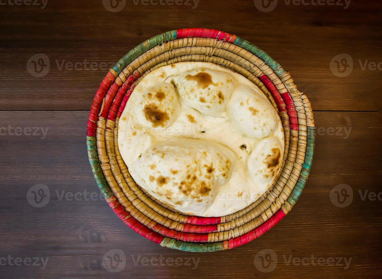 Tandoori khamiri roti served in basket isolated on table top view of india and pakistani food photo