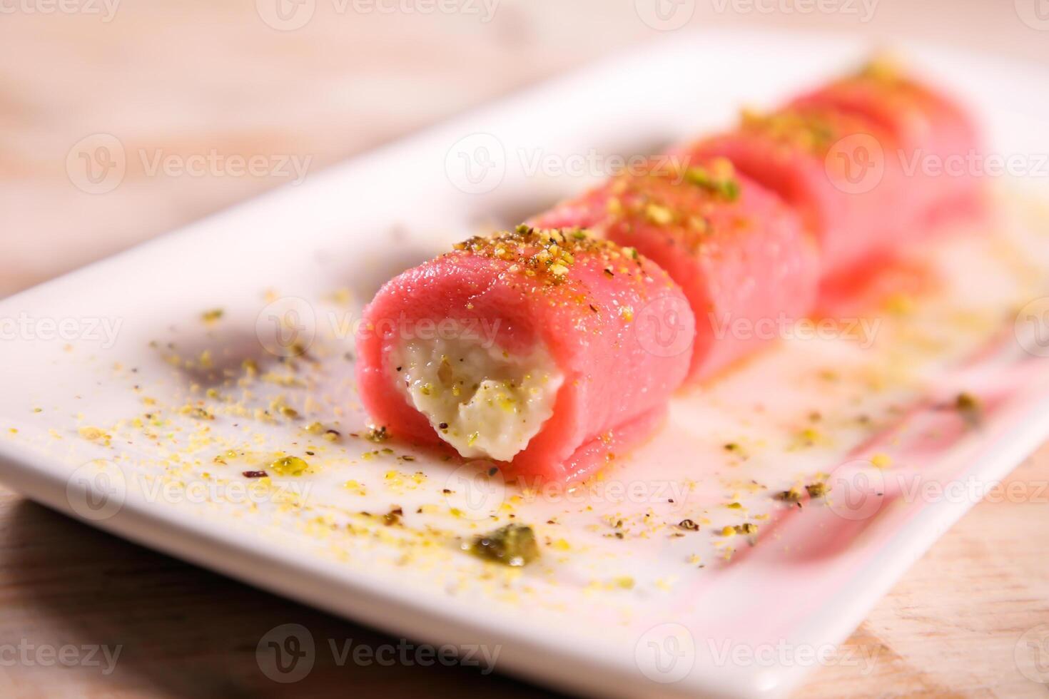 Halawat al jibin bil ward sweet served in dish isolated on table top view of arabic dessert photo