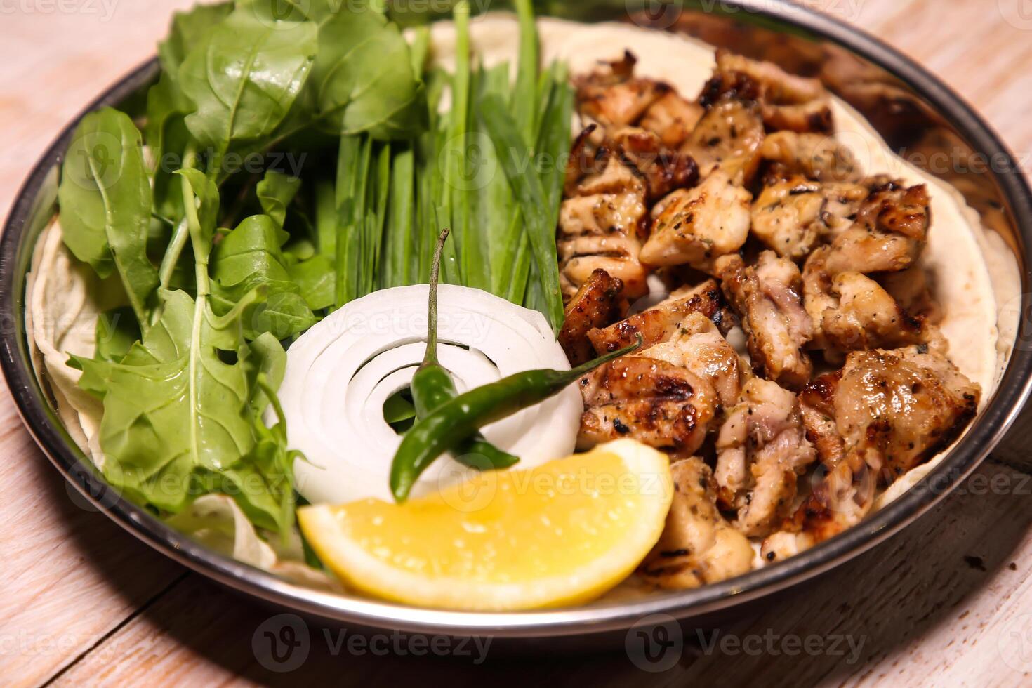 Chicken tikka Dajaj with salad, wedges, lemon and dip served in dish isolated on background top view of arabic food photo