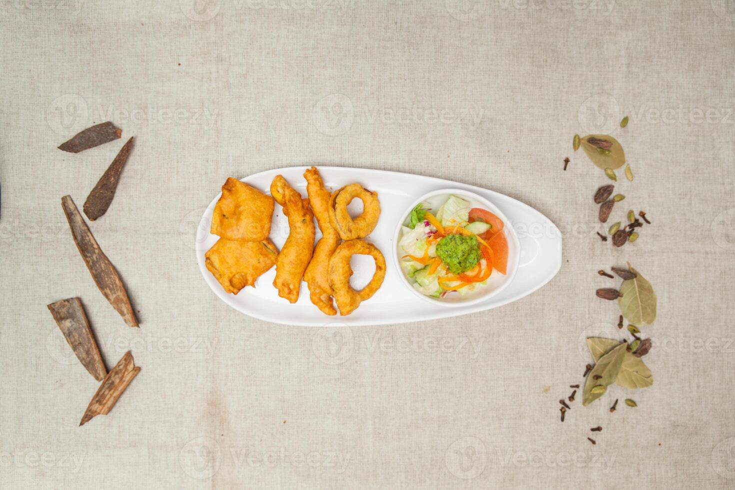 crunchy pakora with onion, murgh, chicken, baigan, salad and chutney served in a dish isolated on table top view of indian spices food photo