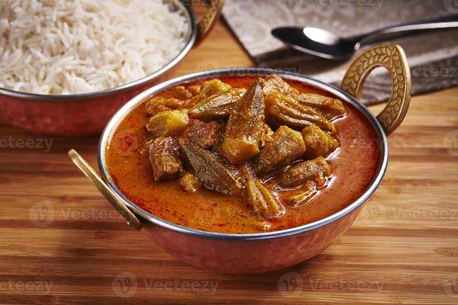 Okra Stew with white rice Khoresht Bamia or lady finger curry served in dish isolated on table side view of middle east food photo