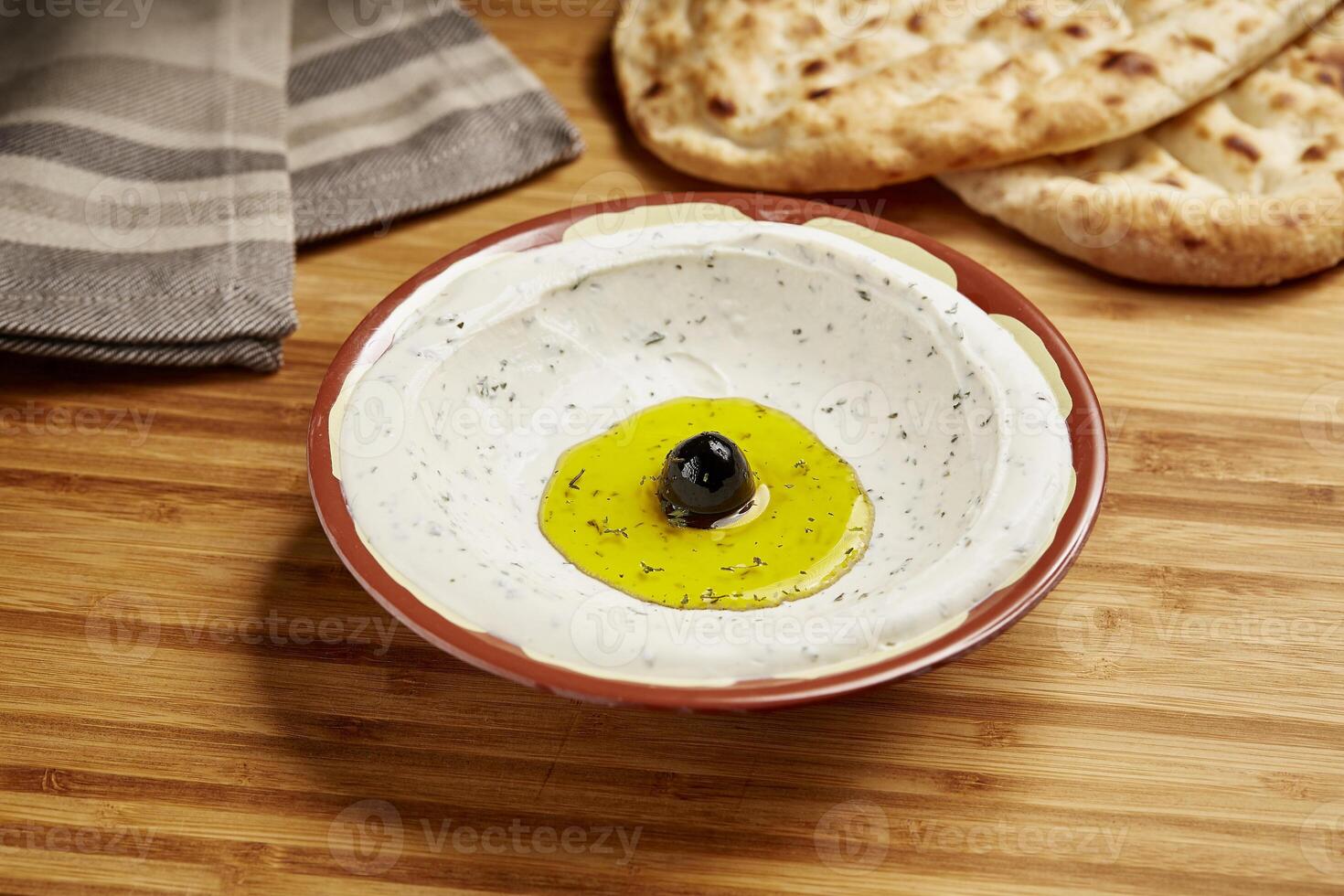 Labnah with Bread served in dish isolated on table side view of middle east food photo